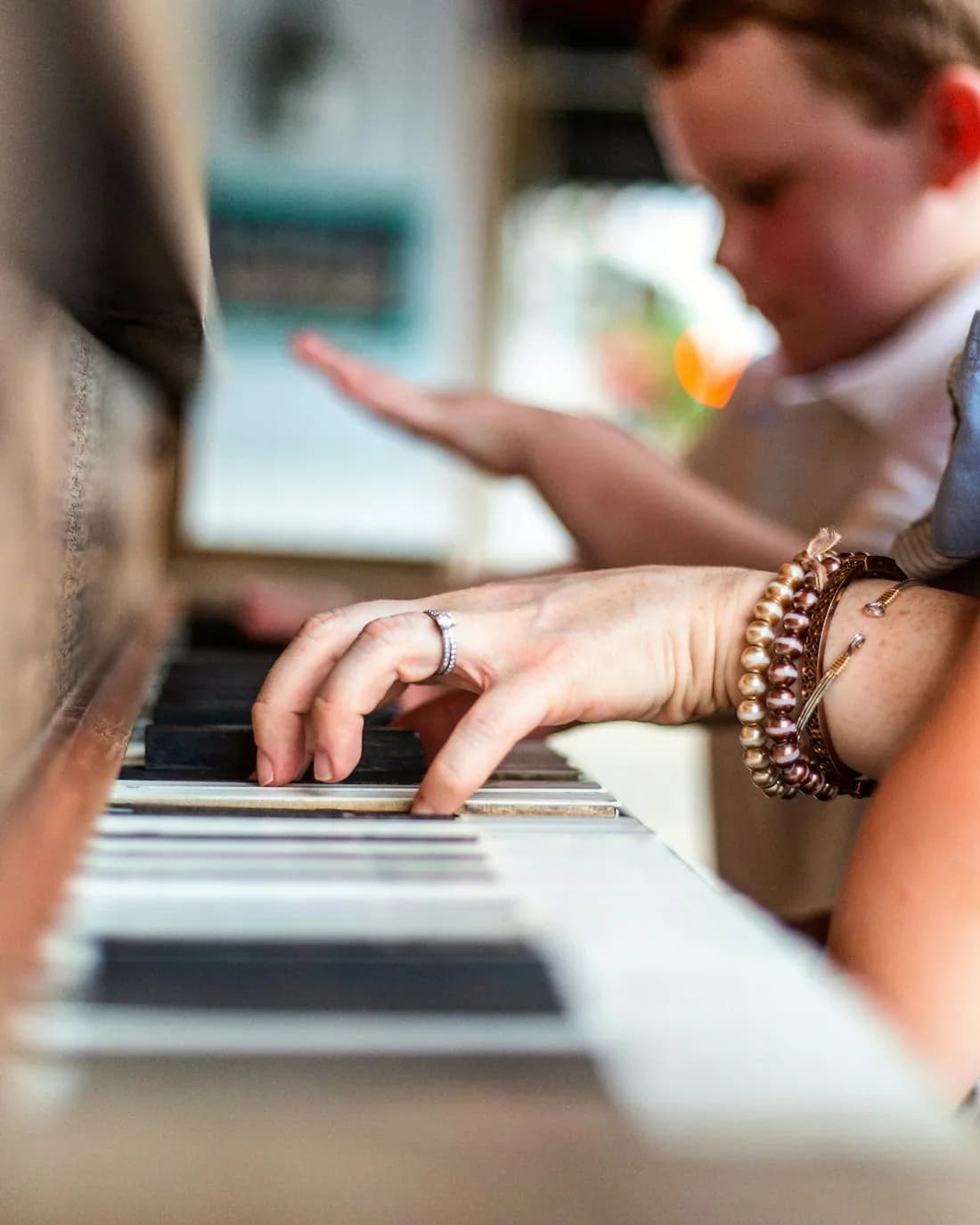 Hands at a grand piano, illustrating a one-to-one lesson